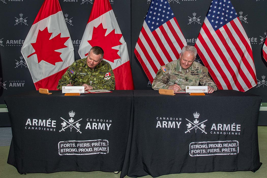 Major-General Conrad Mialkowski, Deputy Commander of the Canadian Army, and Lieutenant General John R. Evans, Jr. Commander of the United States Army North (Fifth Army) and Senior Commander, Fort Sam Houston and Camp Bullis, sign the Bilateral Army Training Strategy during a visit to the Canadian Army Headquarters in Ottawa, Ontario on March 8, 2022. Photo: Sailor First Class Camden Scott, Directorate Army Public Affairs.